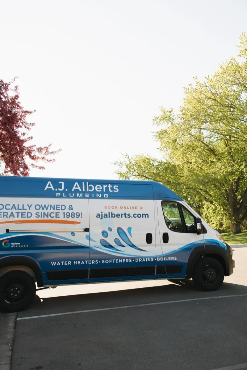 A.J. Alberts Plumbing service van parked outside on a spring morning in the Twin Cities