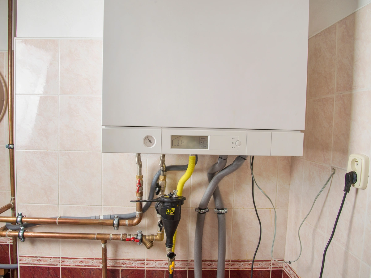 condensing water heater installed on bathroom wall 
