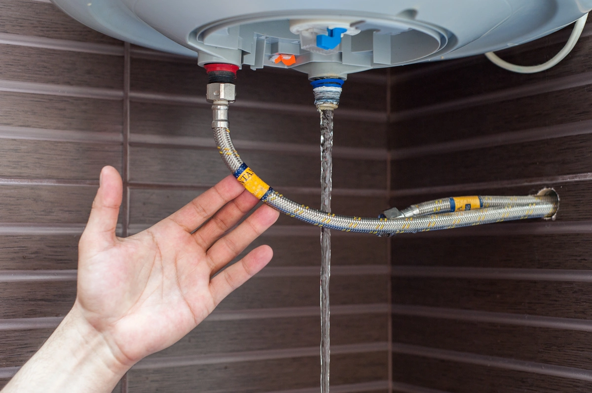 man draining water heater 