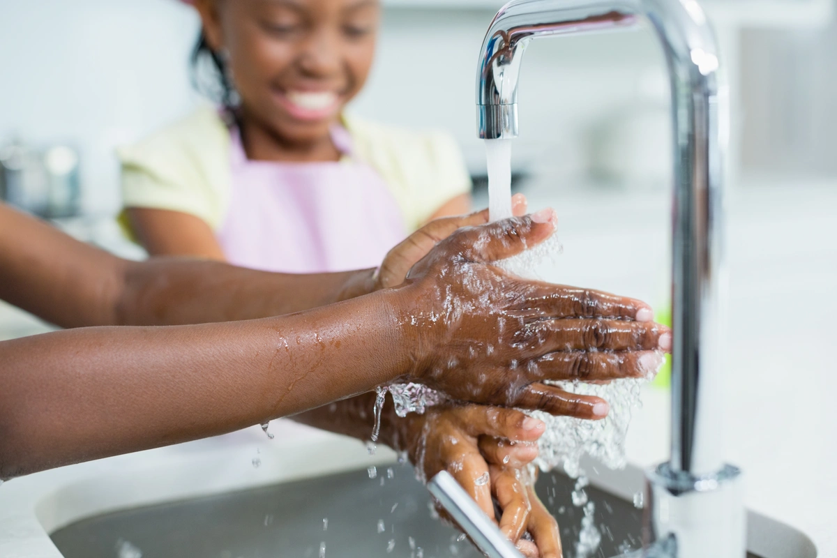 washing hands in kitchen sink