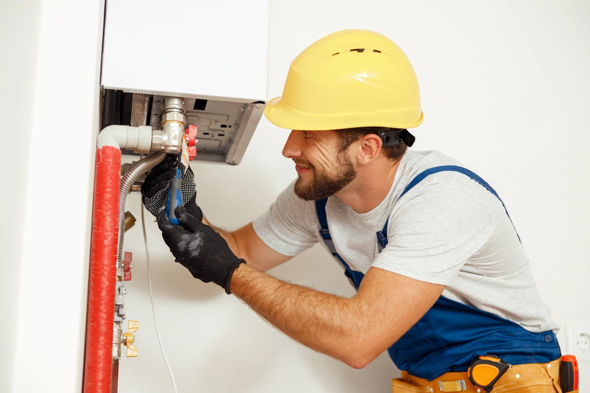 man repairing the water heating system of the house