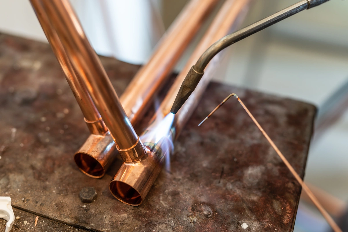 plumber welding copper pipe