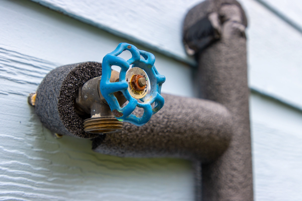 Insulated pipes and outdoor faucet in winter