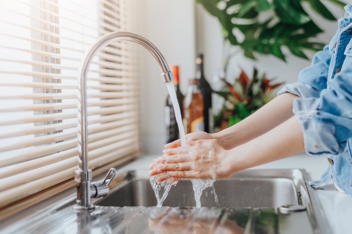 woman washes hands with soft water