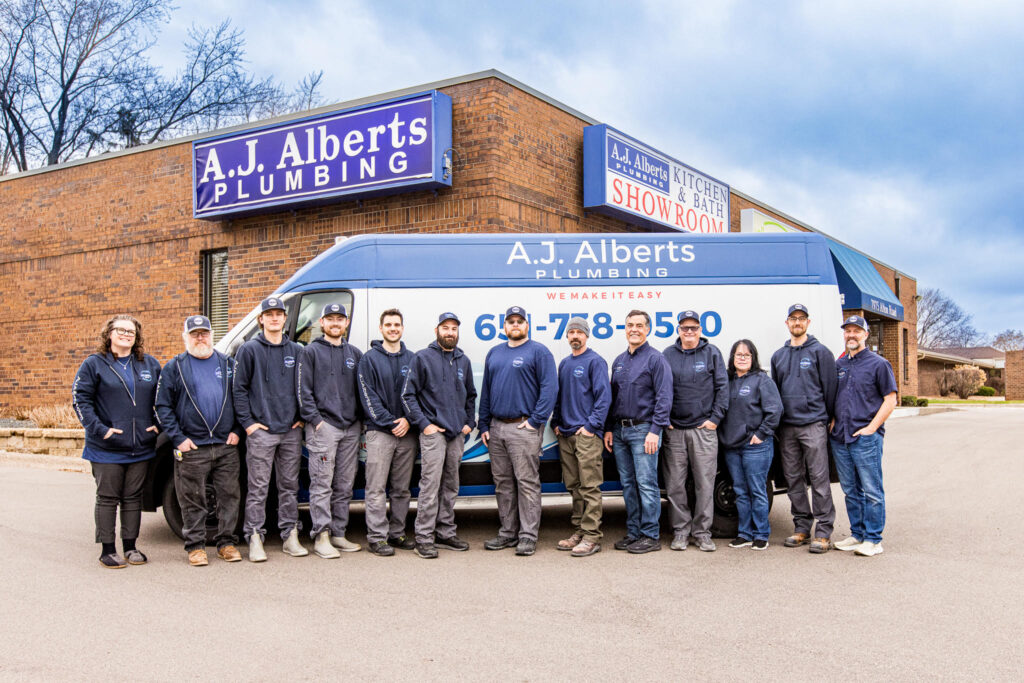 The A.J. Alberts team stands in front of their van and business.