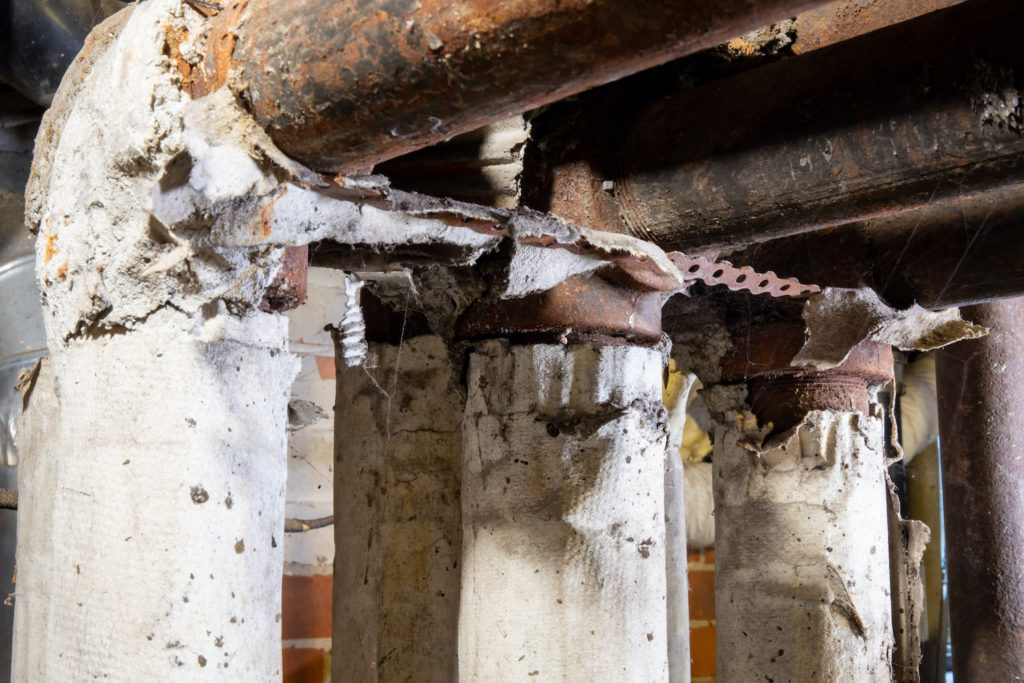 old pipes with dangerous asbestos pipe insulation