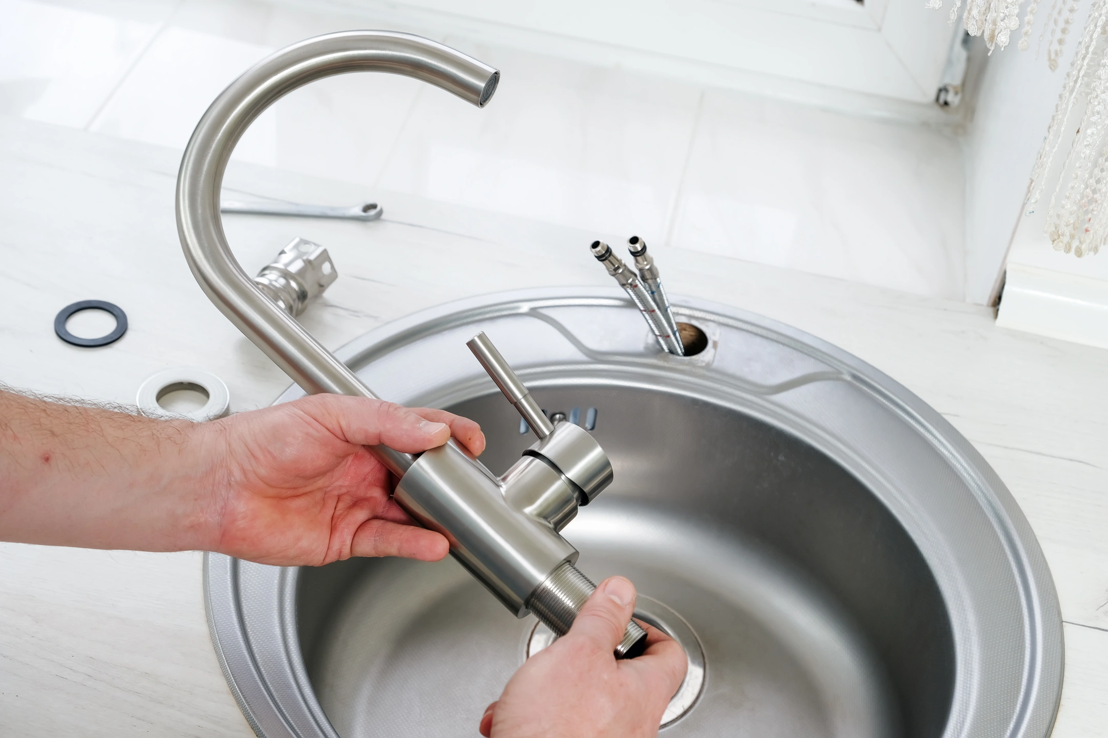plumber installs delta faucets