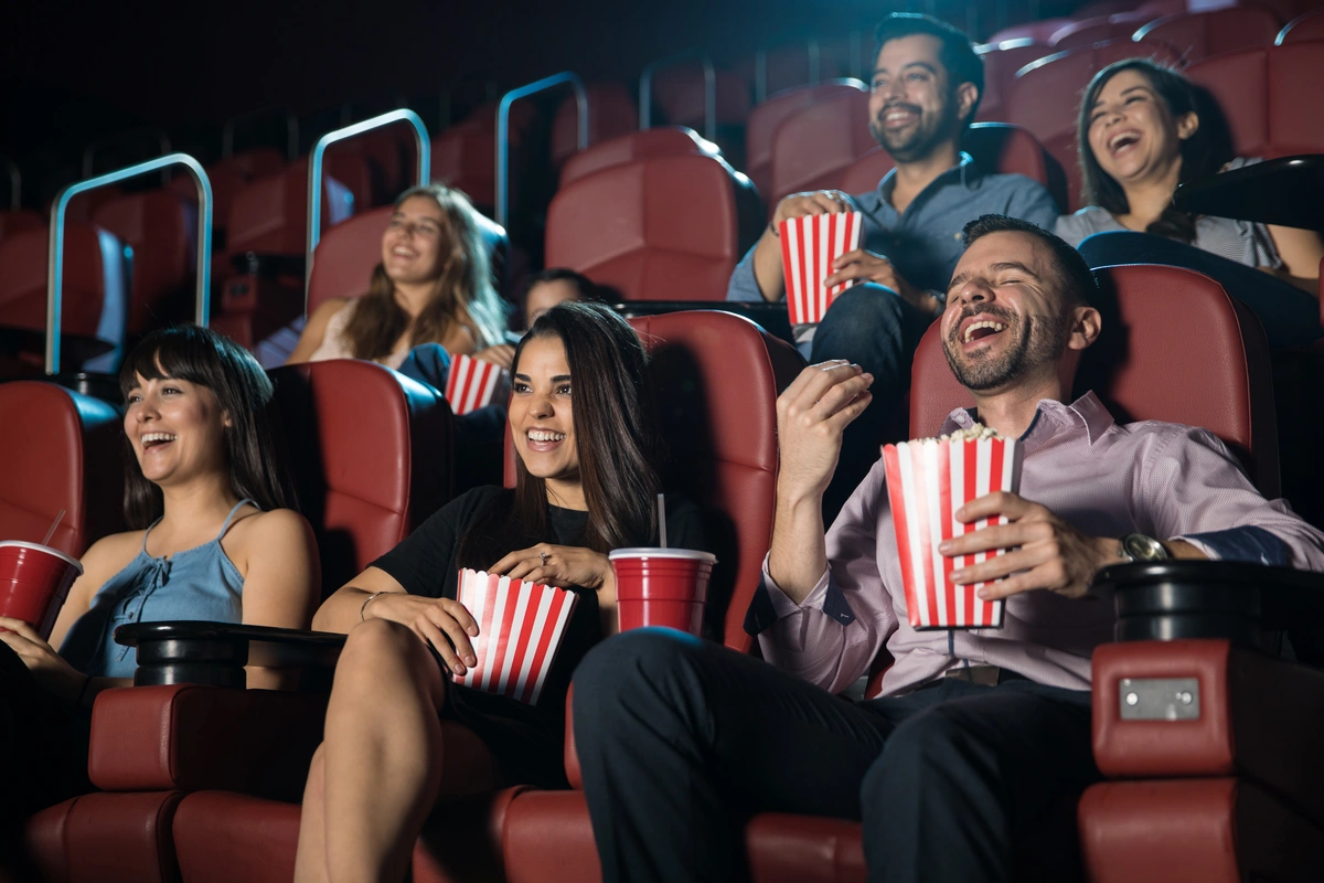 group of friends laughing at the movie theatre
