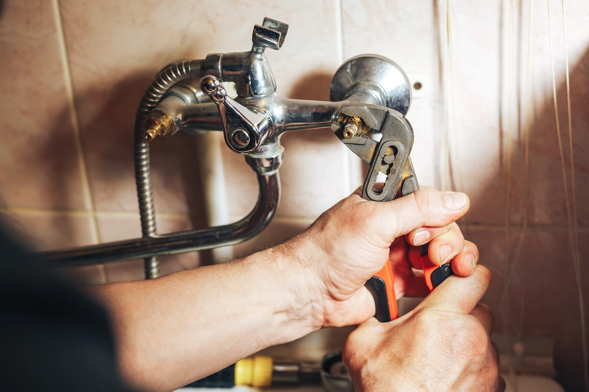 technician repairing the leaky faucet