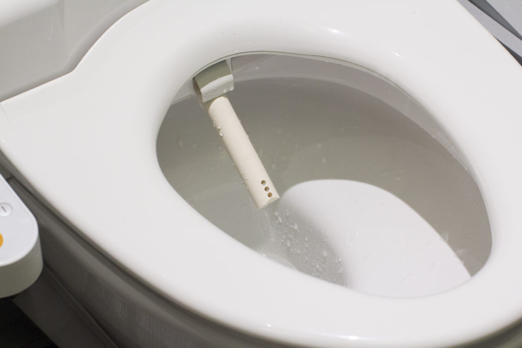 white washlet attached to white toilet seat